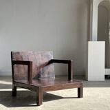 Small low armchair in varnished brown wood