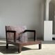 Small low armchair in varnished brown wood
