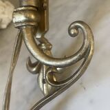 Adjustable wall light in brass and gold metal.