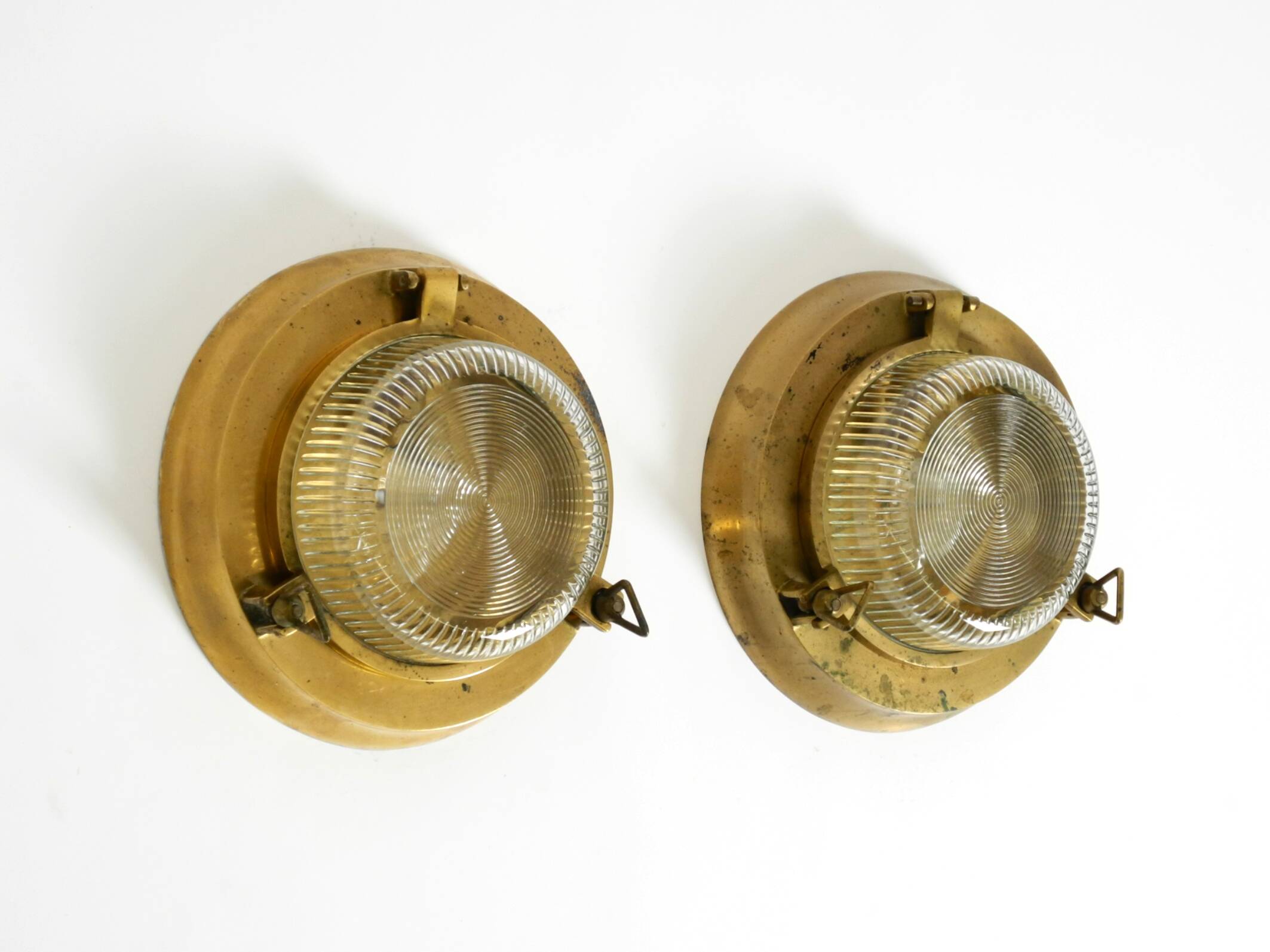 A pair of large, heavy 50s maritime ship wall lamps made of brass and glass