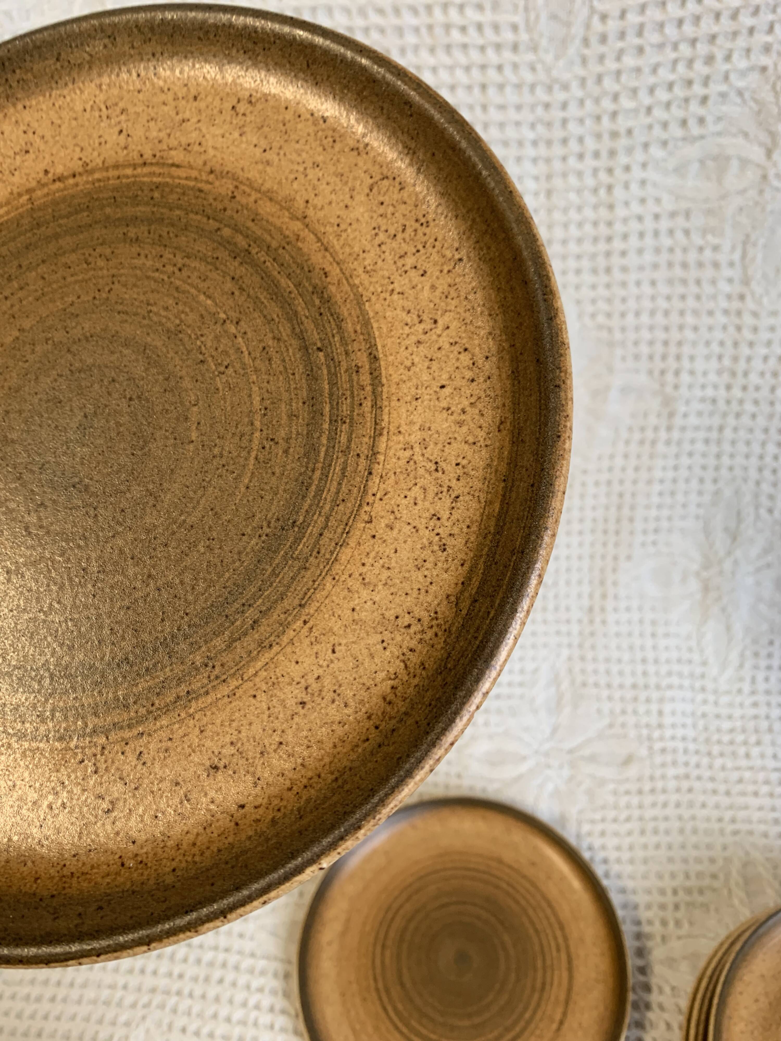 8 Longchamp enamelled stoneware plates, 1970