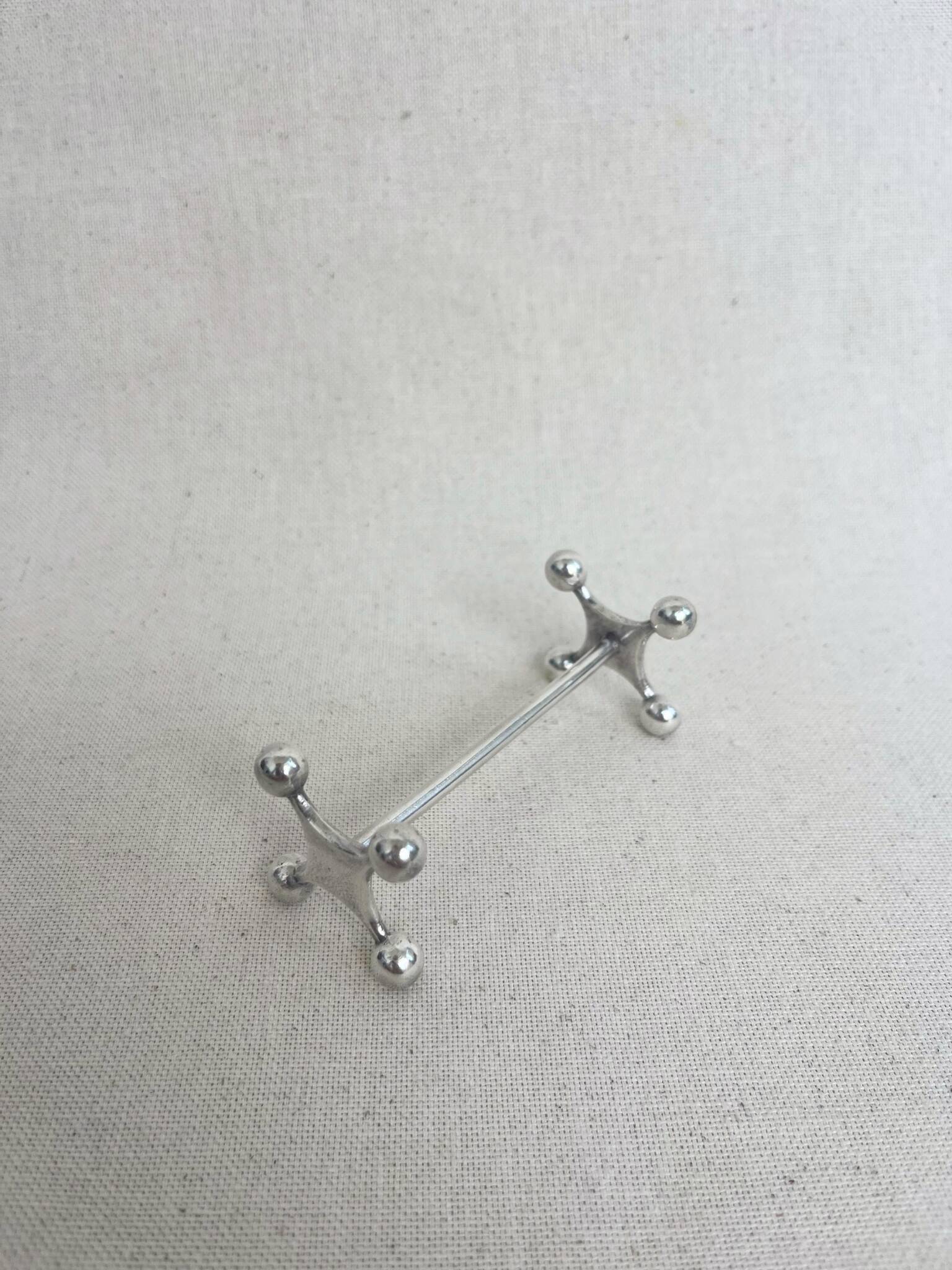 series of brutalist and sculptural silver-plated knife rests