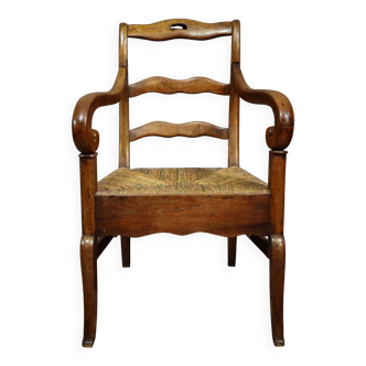 Empire armchair in solid walnut with woven straw seat.