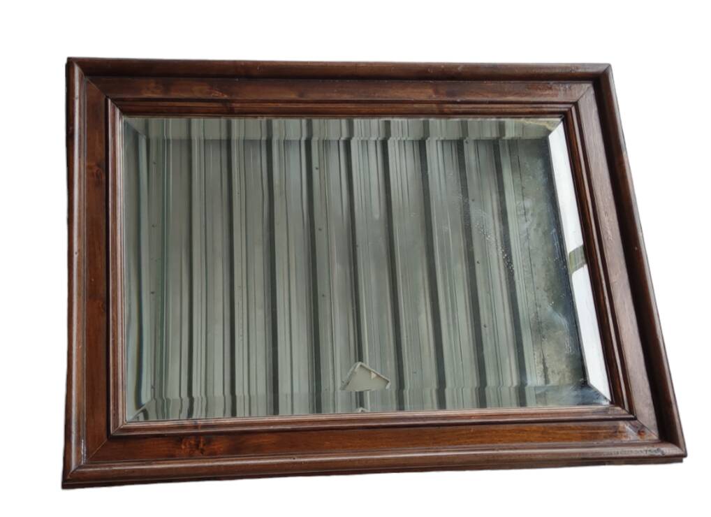 Old beveled mirror with wooden frame