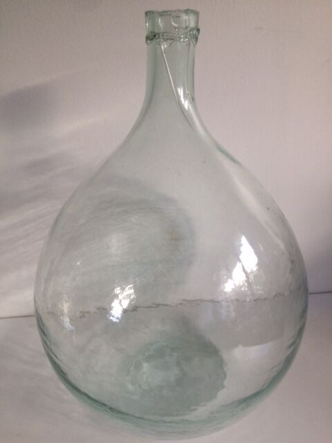 Transparent old demijohn about 8 to 10 L
