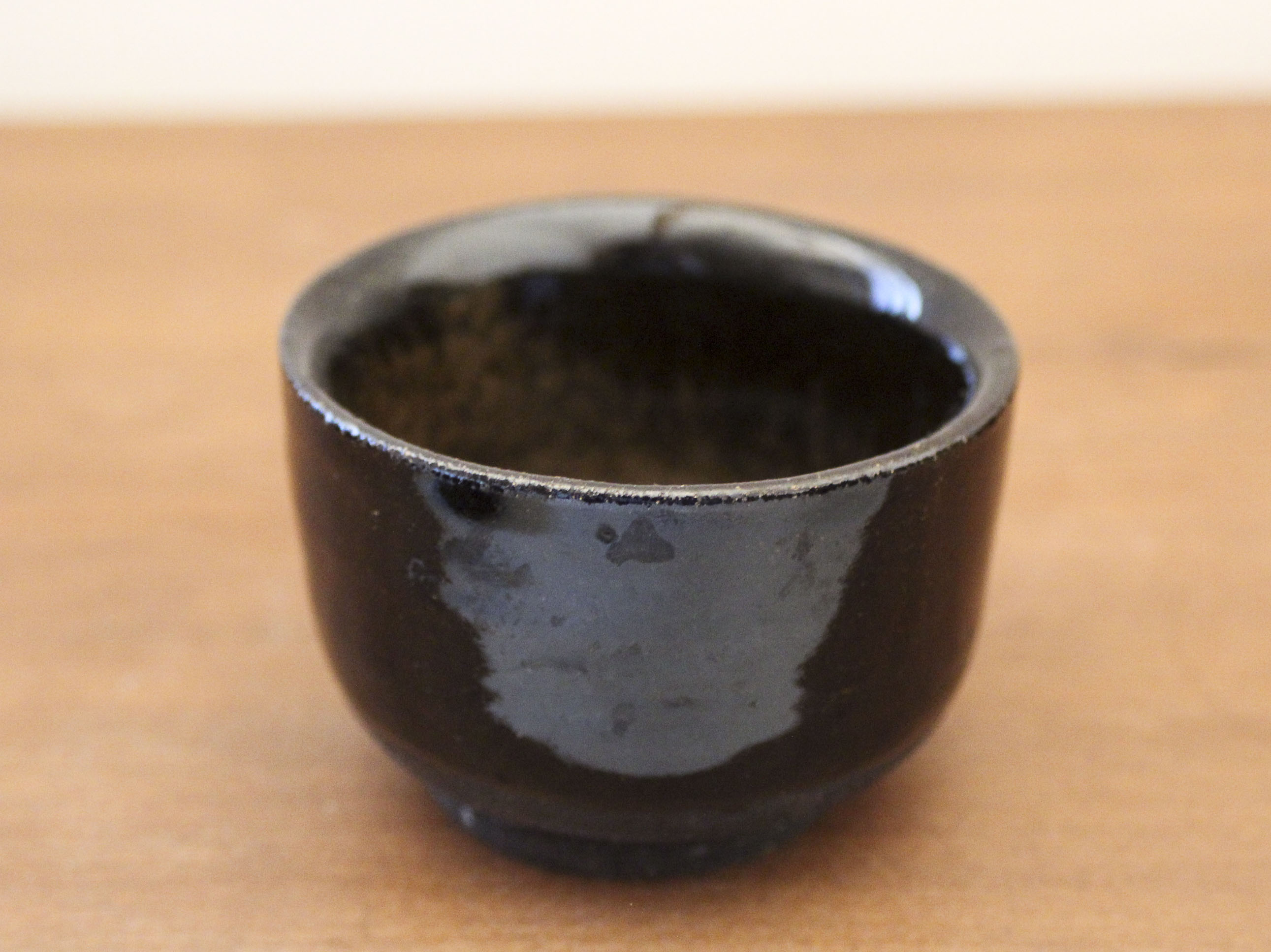 Set of 8 black ceramic cups signed