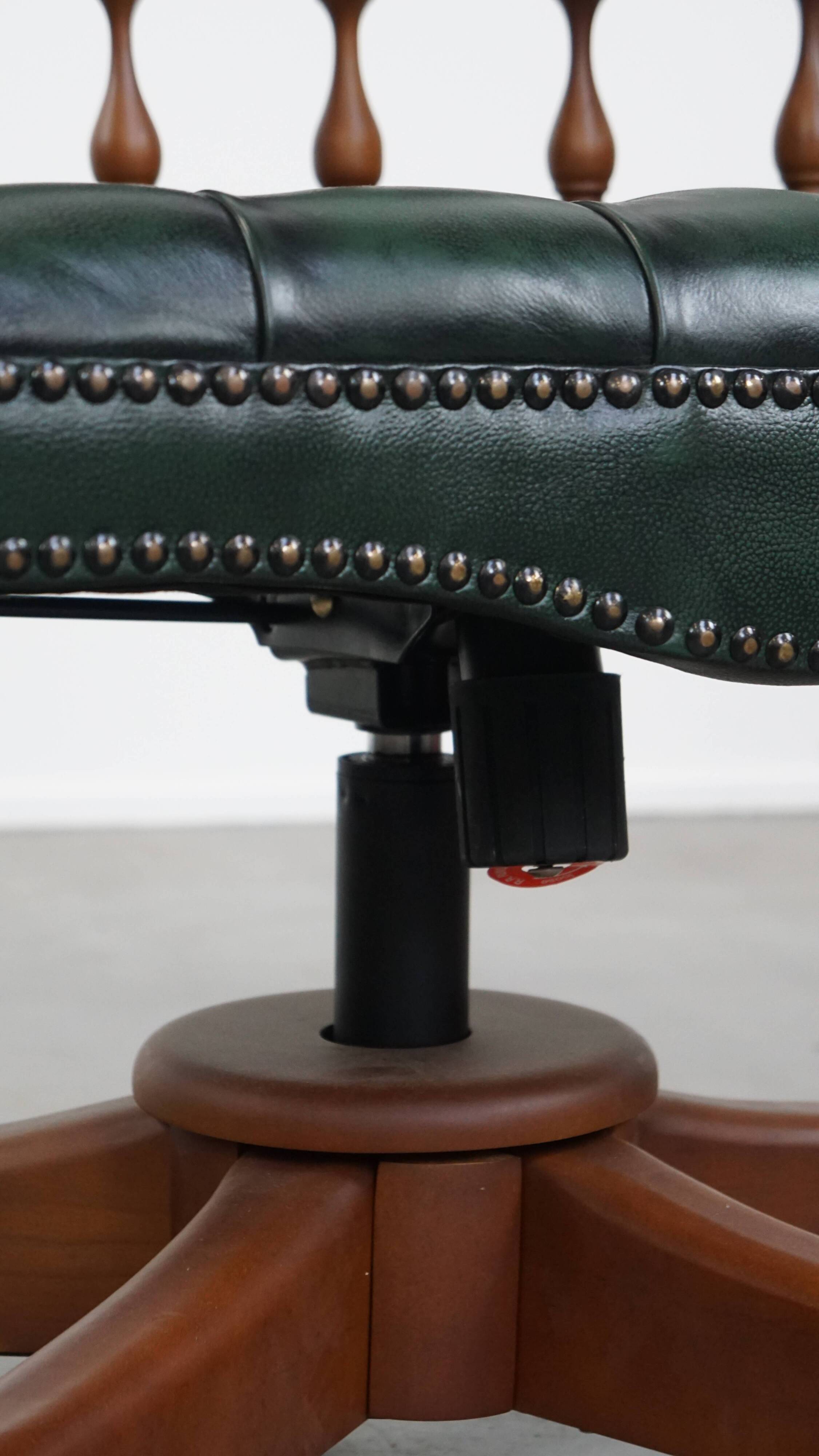 Dark green chesterfield office chair in cowhide leather on wheels