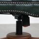 Dark green leather Chesterfield office chair on wheels.