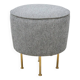 Modern pouf from the Gubi brand in grey fabric and brass.