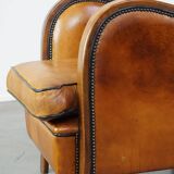 Unique, luxurious sheepskin armchair combined with wood and finished with decorative nails