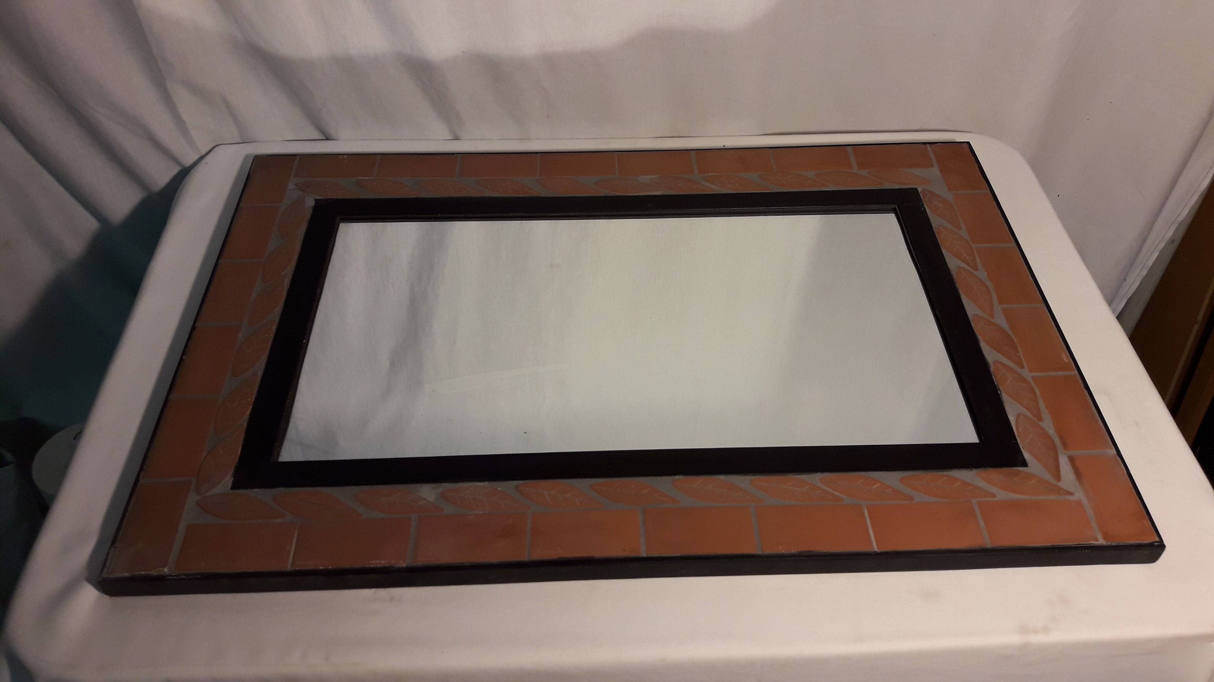 Mirror with terracotta frame