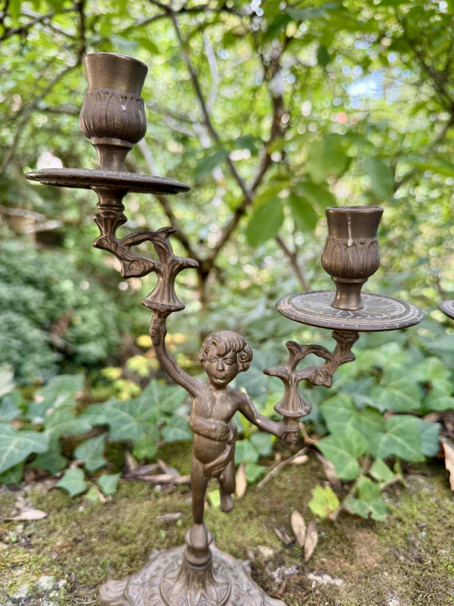 Pair of brass cherub candlesticks