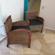 2 colonial-style armchairs in woven rattan and exotic wood