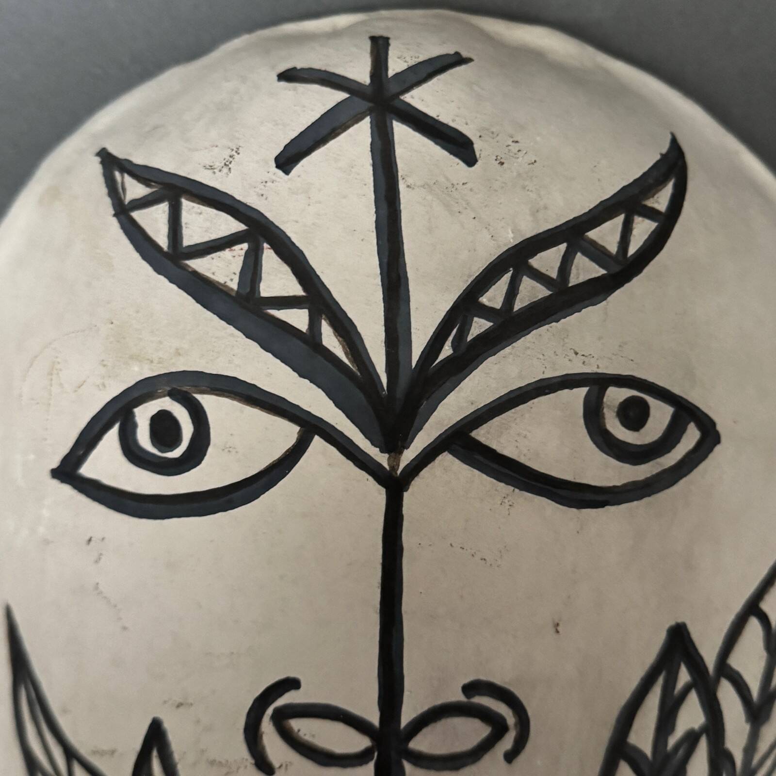 Africanist mask in glazed white terracotta, face signed Colette.