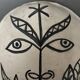 Masque africaniste en terre cuite émaillée blanche visage signé Colette