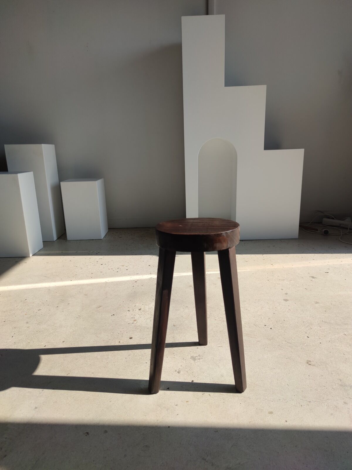 Small high tripod stool in brown solid wood