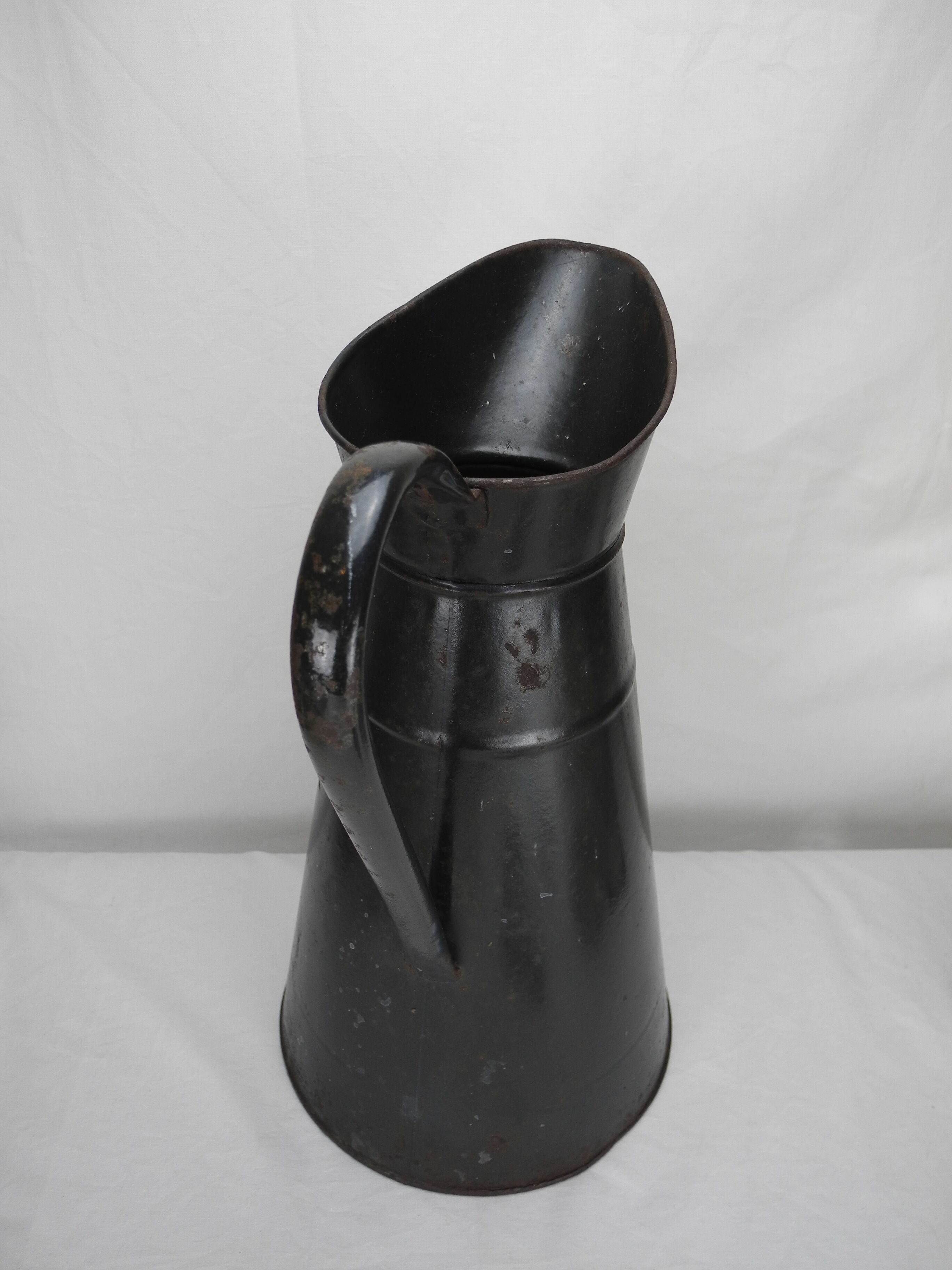 Old enamelled sheet metal jug
