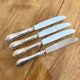 Series of 4 silver metal rocaille knives