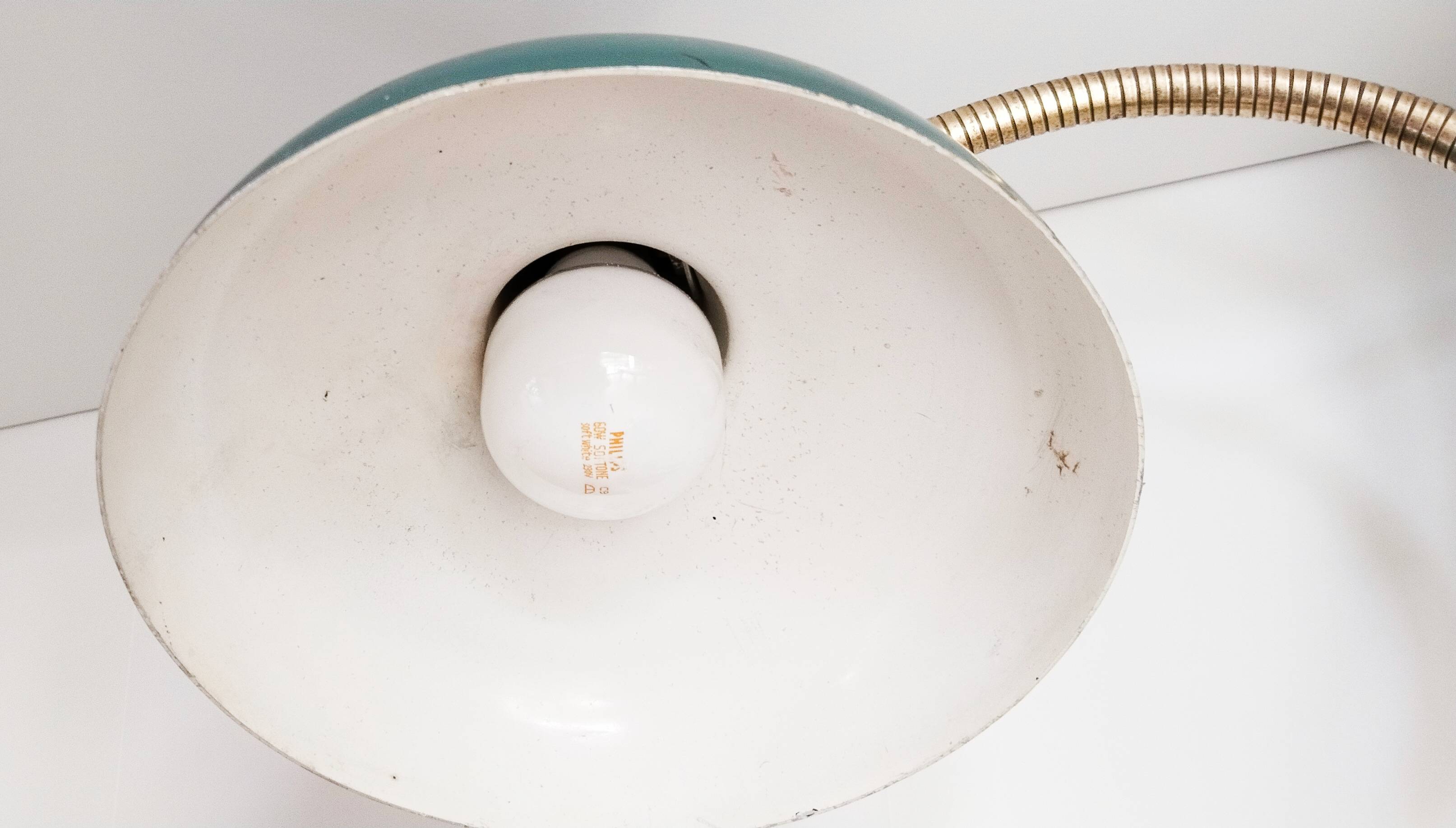 Green and gold articulated desk lamp