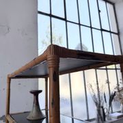 Rattan bookshelf and black glasses