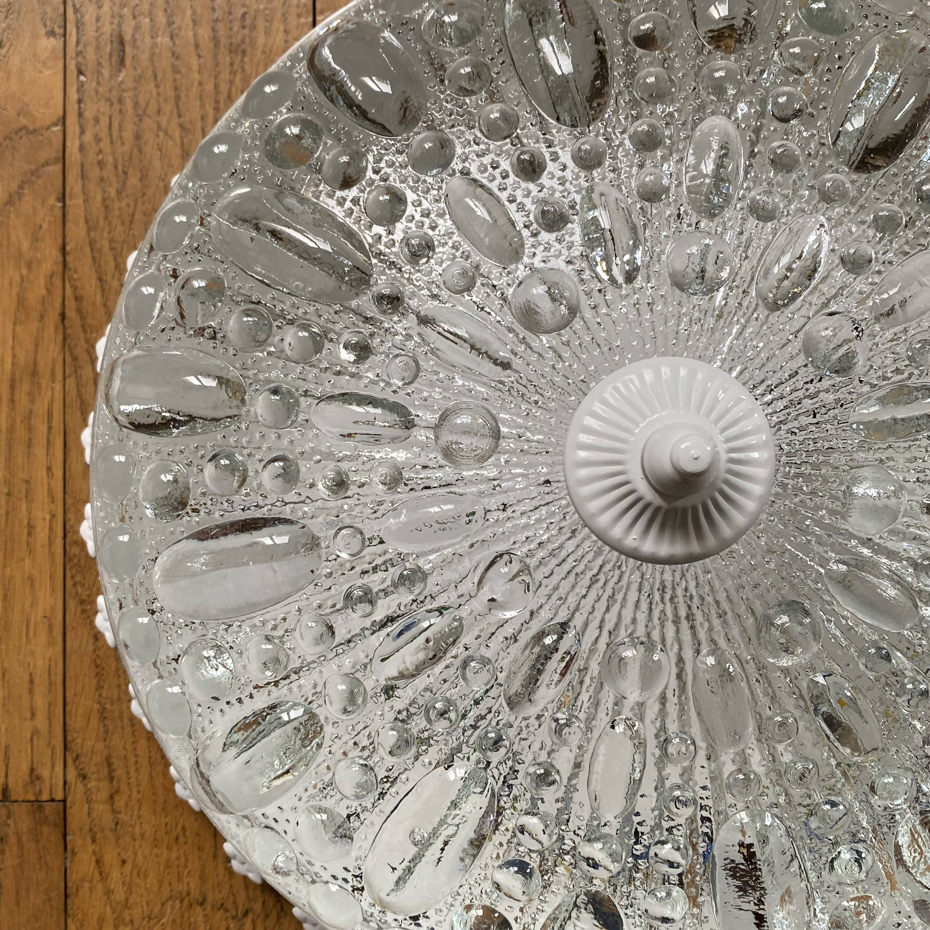 Antique ceiling light with transparent glass and white metal.