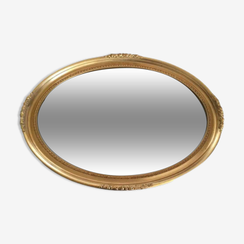 Miroir ovale biseauté cadre bois doré sculpté