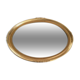 Beveled oval mirror with carved gilded wood frame