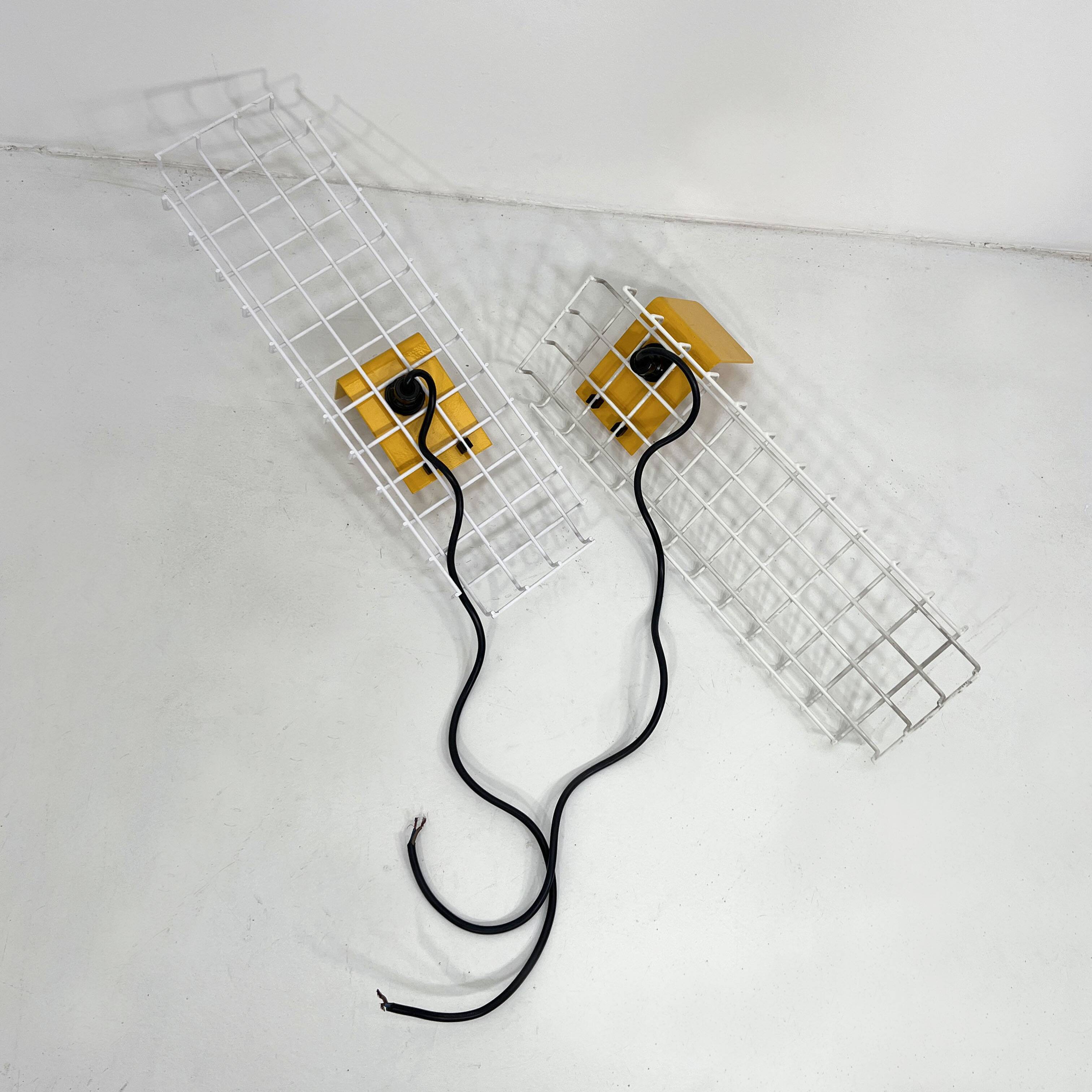 Pair of yellow wall sconces on wire mesh by Seccose, 1980
