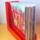 33 rpm vinyl record rack, in orange 70s plastic.