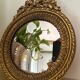 Round golden convex mirror with mouldings - witch's mirror
