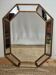 Bevelled mirror with neoclassical parcloses from the 20th century.