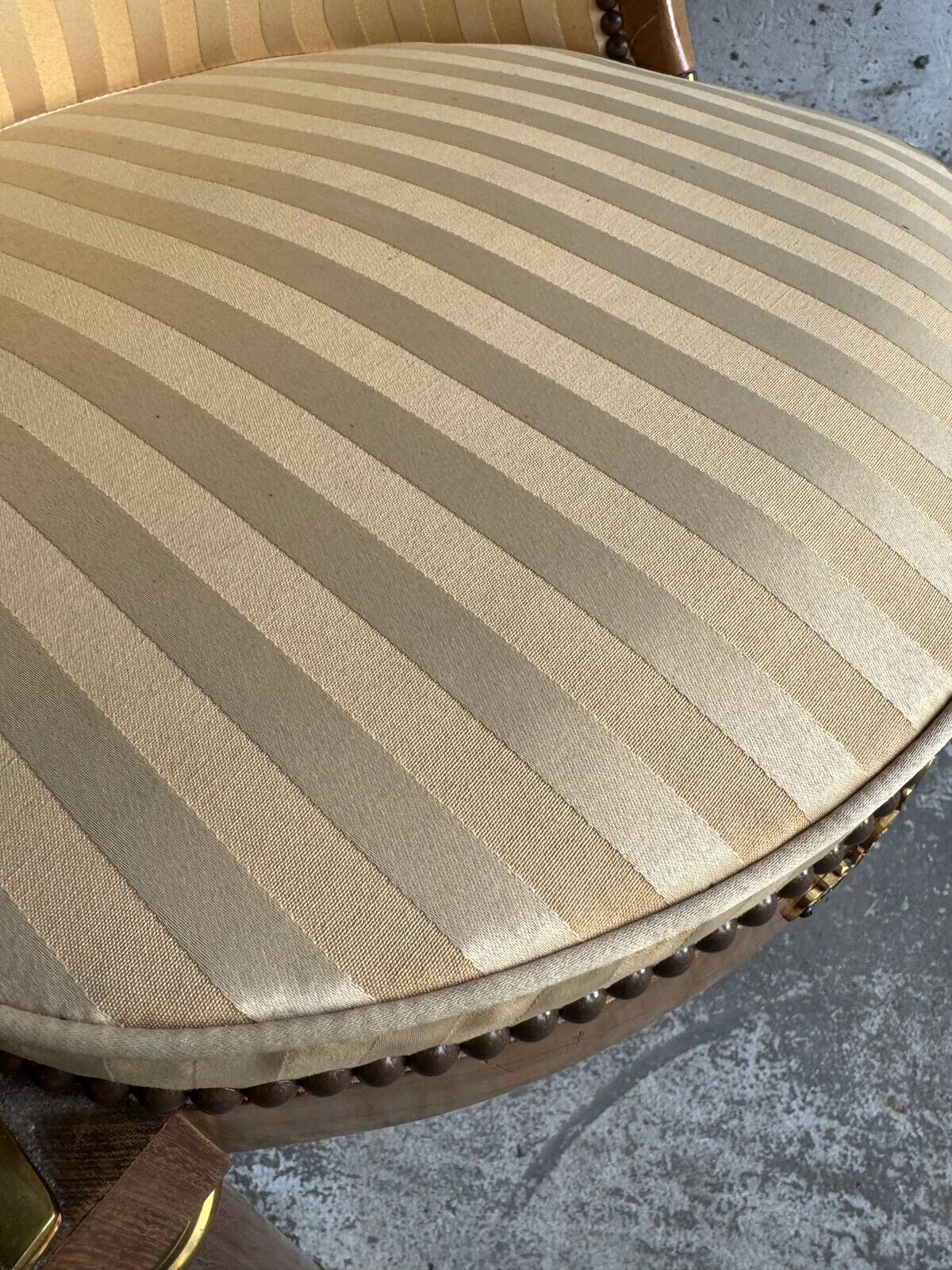 DeCoene antique wood writing desk with beige striped upholstered chair, brass-accented classic set