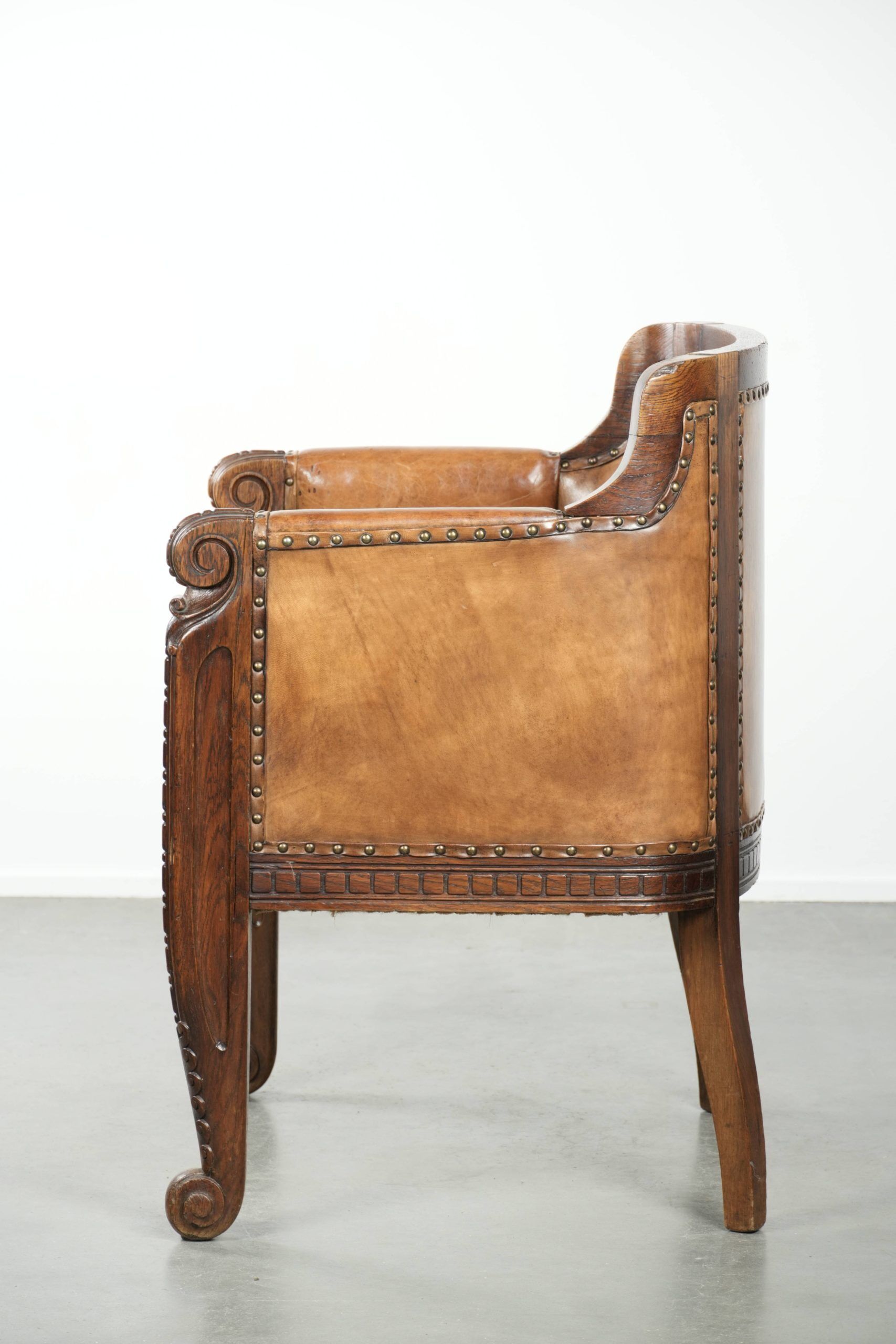 Antique armchair made of sheepskin and wood with decorative nails