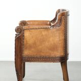 Antique armchair made of sheepskin and wood with decorative nails