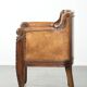 Antique armchair made of sheepskin and wood with decorative nails