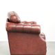 Cowhide chesterfield armchair in a warm brown colour with decorative nails