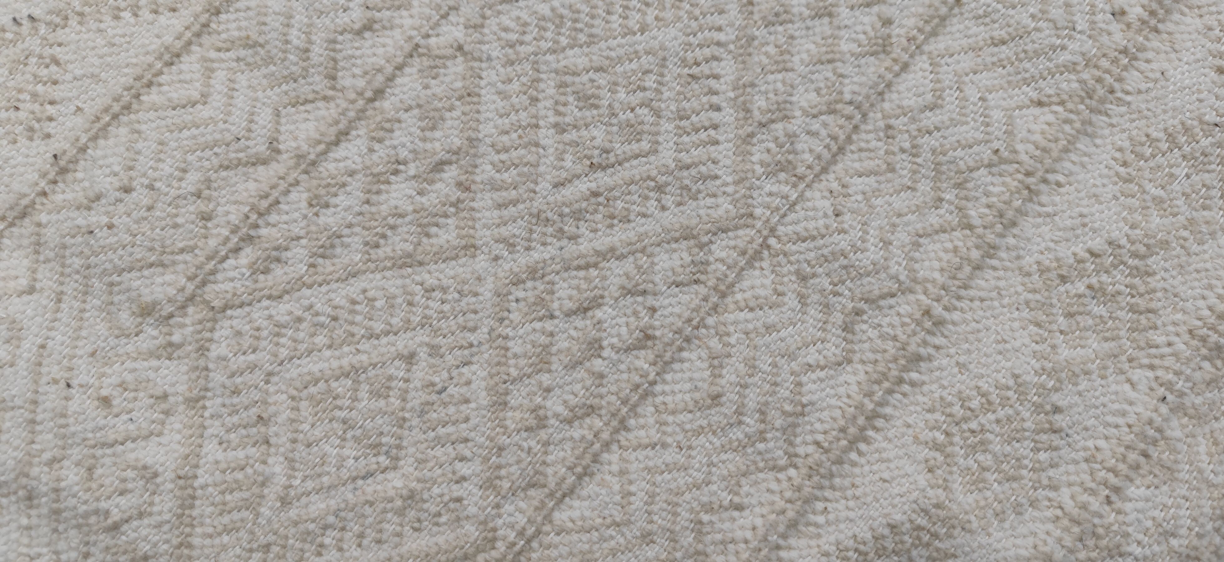 Hand-woven rug in natural wool