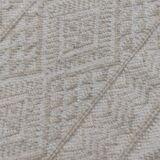 Hand-woven rug in natural wool