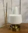 Table lamp in gold metal and opaline.