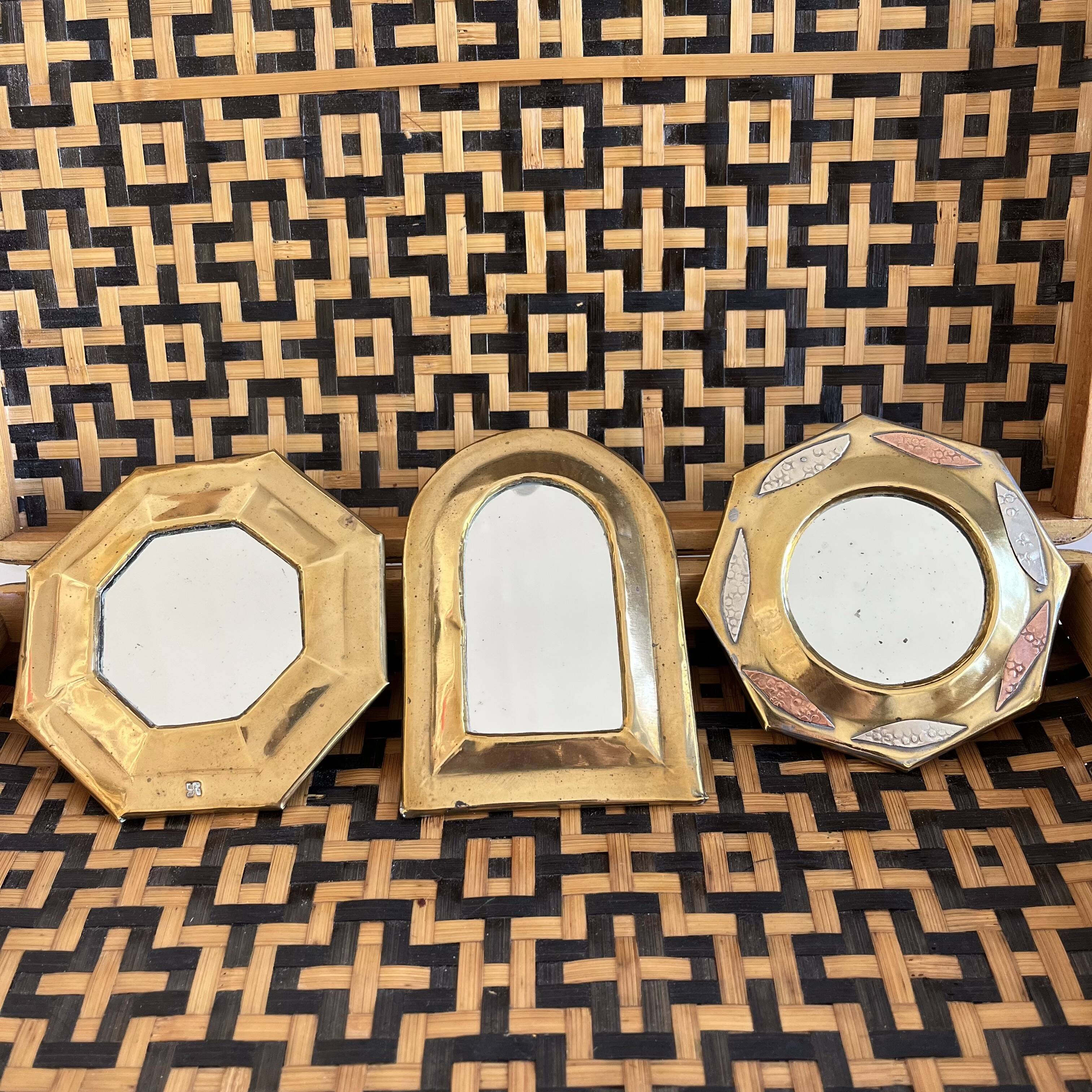 Trio of small brass mirrors