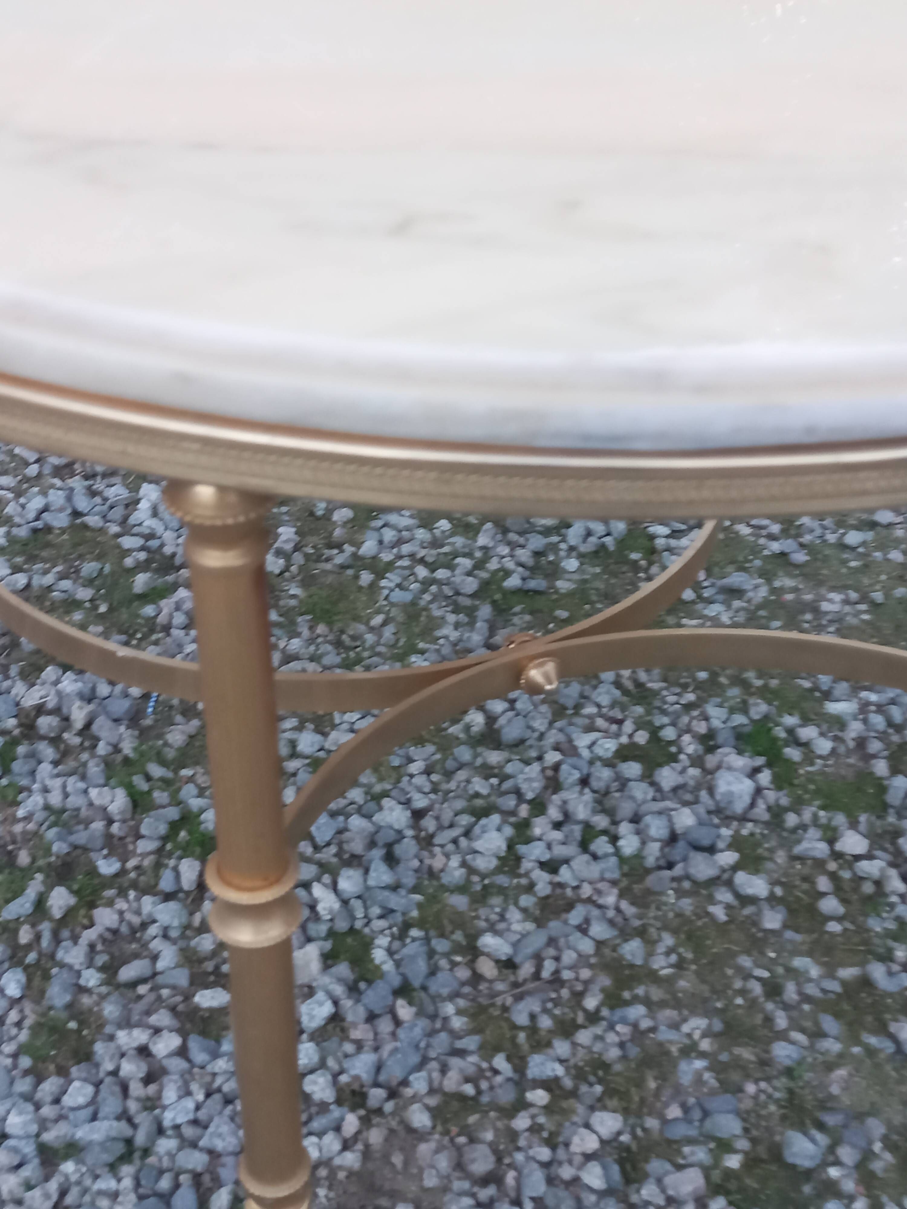 Round neoclassical coffee table with a marble top and golden metal base.