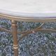 Round neoclassical coffee table with a marble top and golden metal base.