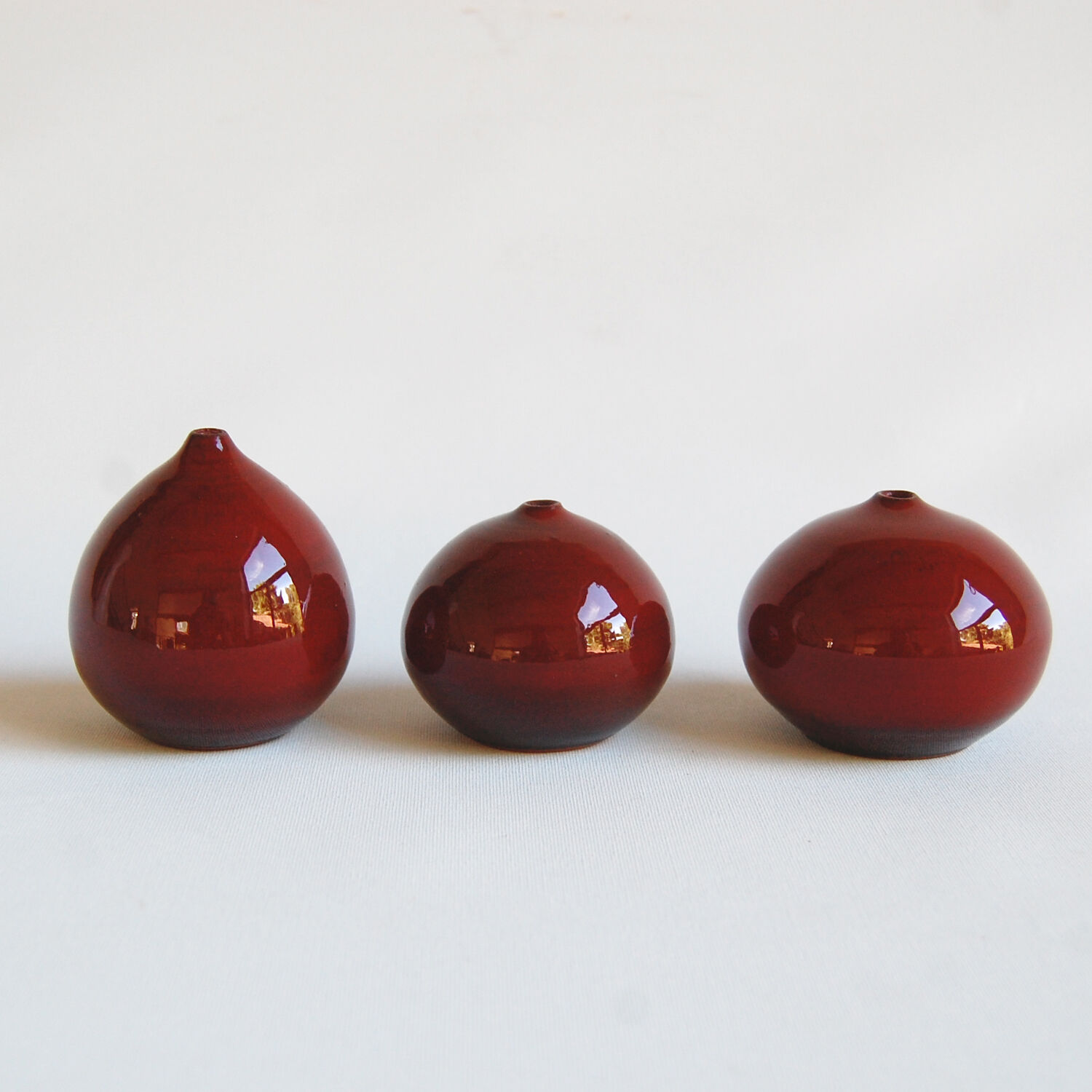 Trio of red miniature ceramics by Antonio Lampecco