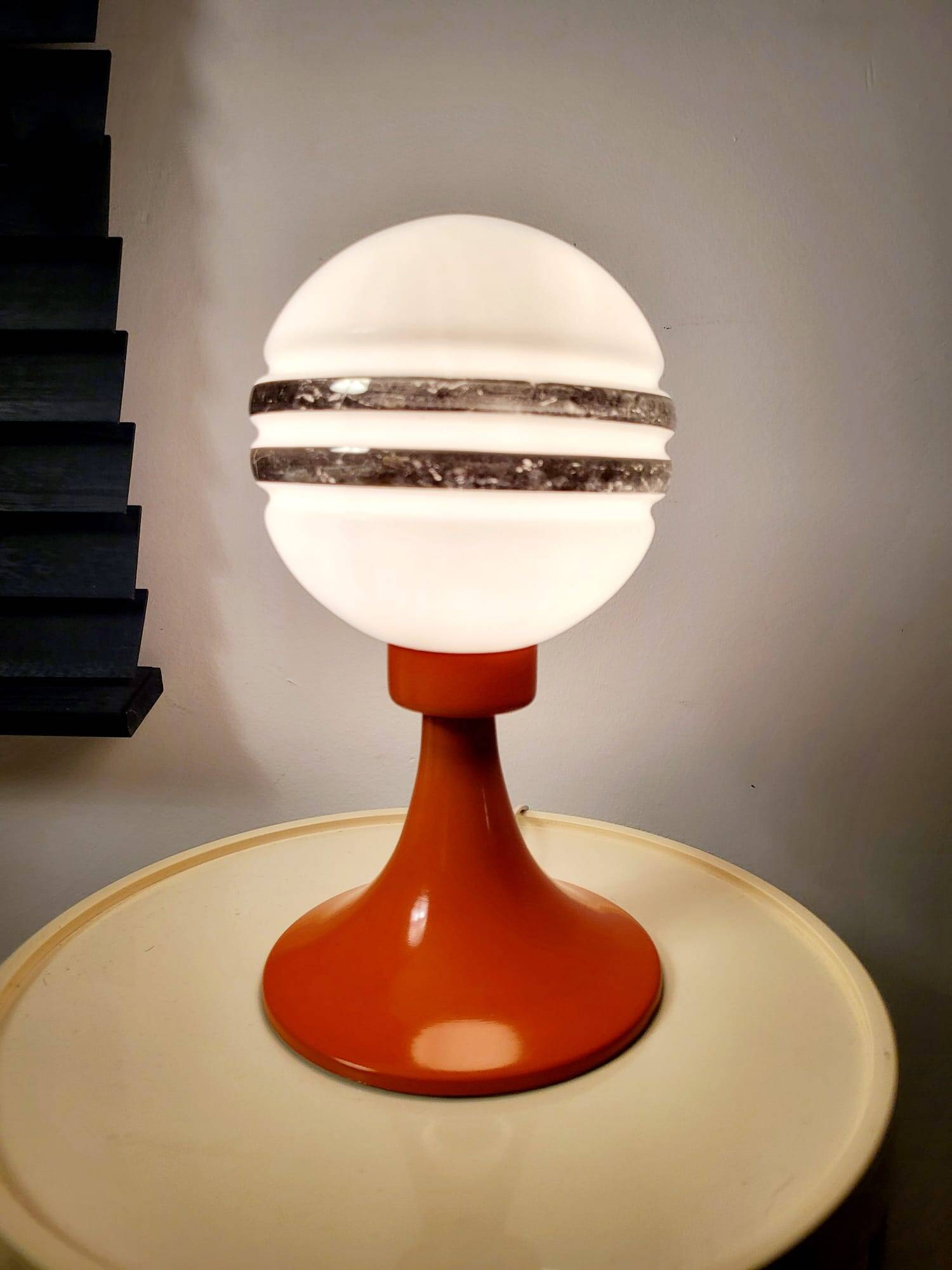 Orange metal and glass table lamp, circa 1960.