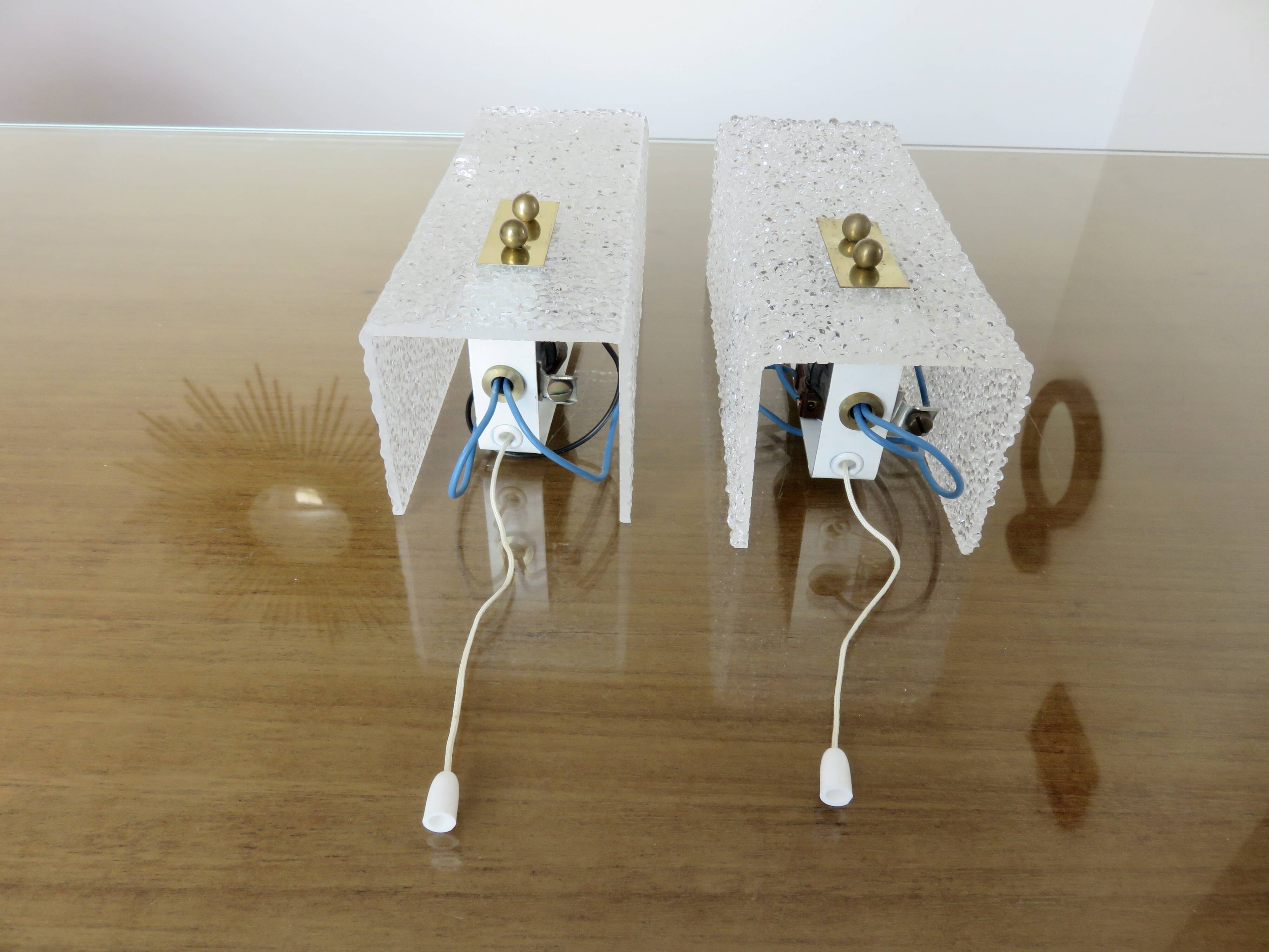 Pair of pull switch wall lights in perspex and gilded brass, France, circa 1960.