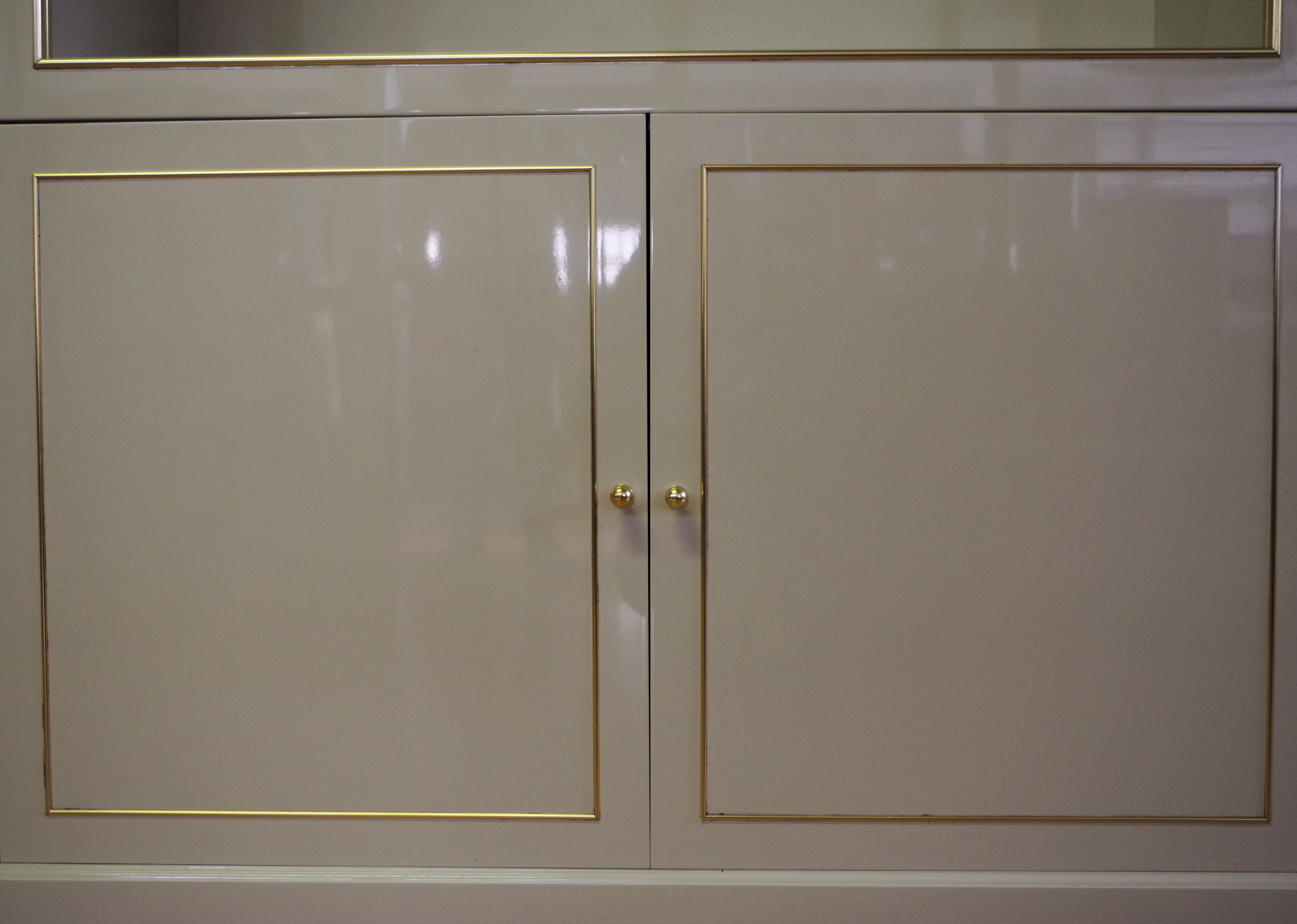 Showcases in lacquered wood, glass and brass  1970s, set of 4