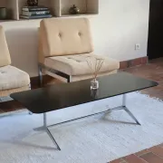 70s design coffee table with a black top and steel legs.