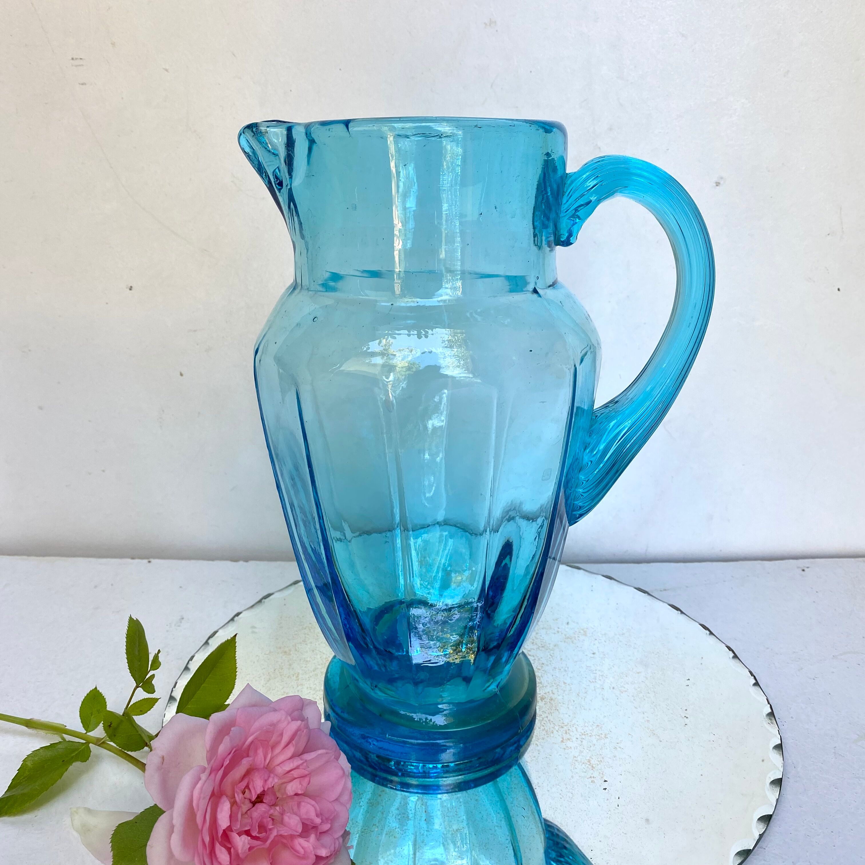 Old pitcher in blue glass