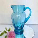 Old pitcher in blue glass