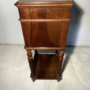 Antique wooden bedside table with turned legs.